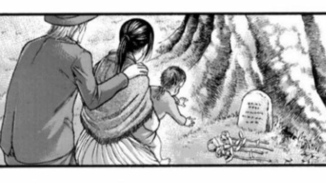 Mikasa visitando la tumba de Eren con su hijo y su marido.