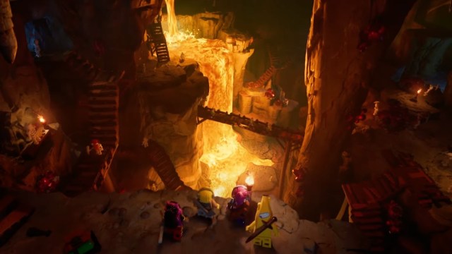 Un grupo de personajes mirando hacia una cueva subterránea en LEGO Fortnite.