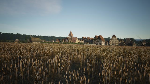 Un pueblo medieval con un campo de cereales y edificios en la distancia.