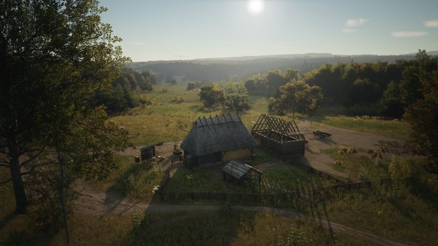 Dos casas medievales en medio de un campo, una en construcción